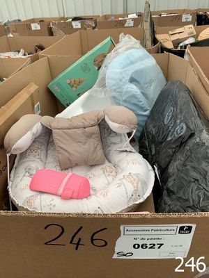 a cardboard box filled with lots of stuff and a stuffed animal