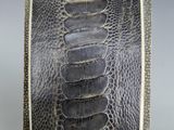 a close up of a black and white snake skin wallet