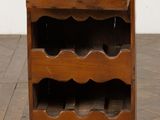 a small wooden wine rack with many bottles on it
