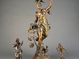 a statue of a woman holding a flower and a bird