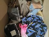 a cardboard box filled with clothes and other items