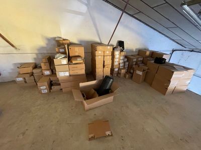 a room full of boxes and a chair in the middle of the room