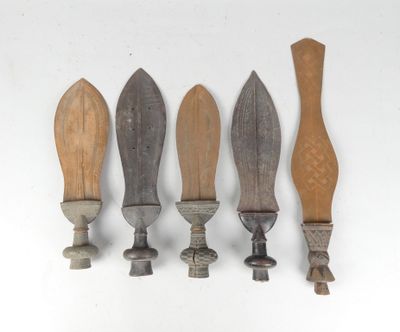 four different types of knives are lined up on a white surface