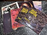a pile of vinyl records sitting on a table