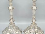 pair of silver candlesticks on a white background