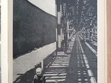 a black and white photo of a person sitting on a bench