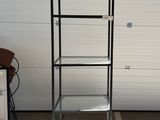 a metal stand with a glass shelf on top of it