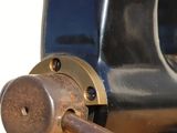 a close up of a machine with a wooden handle