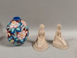 three figurines sitting next to each other on a table