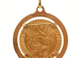 a gold coin hanging from a string on a white background