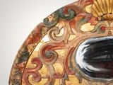 a decorative mirror with a shell in the middle