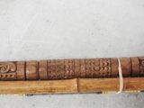 a long piece of wood that has carvings on it
