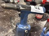 an image of a drill in a workshop with other tools