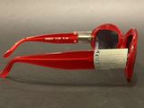a pair of red sunglasses that are on a table