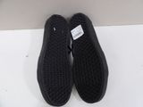 vans slip on shoes with black soles on a white surface