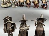 several figurines of people dressed in medieval clothing and hats