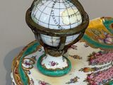 a plate with a globe on top of it