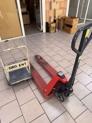a fork lifter sitting on the ground in front of a building