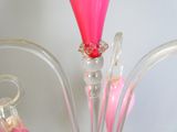 a glass vase with a pink flower inside of it