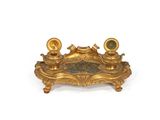 a gold candle holder with two candles on it