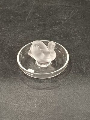 a glass object that is sitting on a black surface