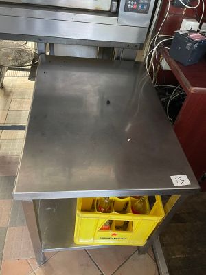 a metal table with a yellow bin in front of it