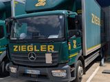 two trucks that are parked in front of a building