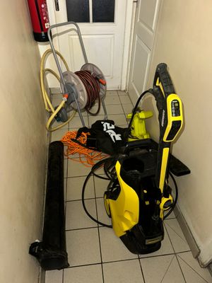 a yellow and black power washer sitting in the corner of a room