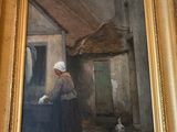 un tableau représentant une femme avec un chat devant un immeuble