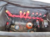 a black bag with tools in it on the ground