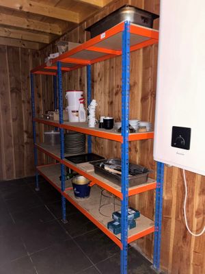 a room that has a shelf with a lot of items on it