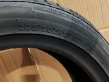a close up of a tire on a wooden surface with a cardboard box in the background