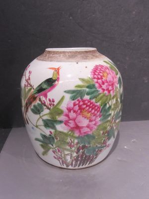 a vase with a bird and flowers painted on it