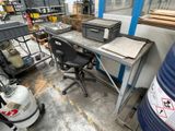 an image of a work area with a desk and a chair