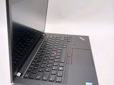 a black laptop with a red button on the keyboard