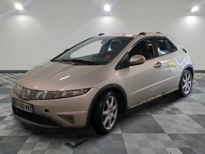 a picture of a beige honda civic car in a showroom