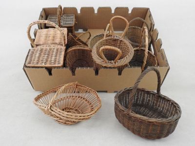 many baskets in a cardboard box on a white surface