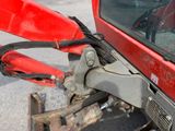 a close up of the front end of a red vehicle