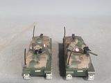 two toy tanks sitting side by side on a table