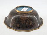 a brown bowl with a blue lid sitting on a white surface