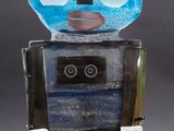 an image of a blue and black robot figurine sitting on top of a table