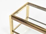 a glass table with a gold frame on top of it
