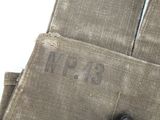 a close up of a pair of gloves with a button