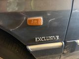 a close up of a car ' s emblem on the side of the car