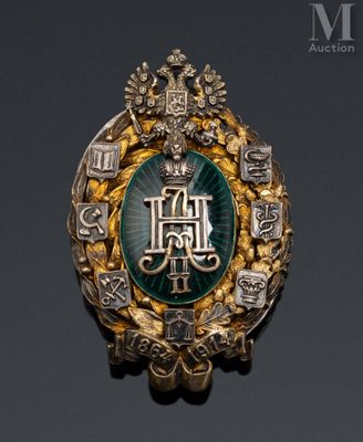 an image of a gold and green broochle with a crown on it