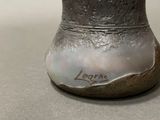 a silver vase with writing on it sitting on a table