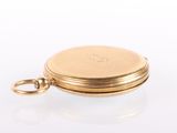an image of a gold pocket watch with a chain on a white surface