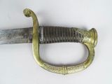 a close up of a sword on a white surface