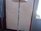 a lamp that is sitting on the floor in front of a window