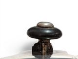 a close up of a metal object on a white surface